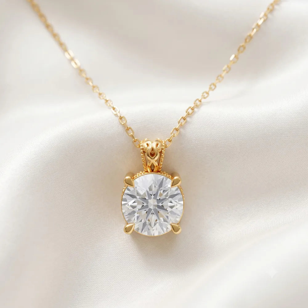 Solitaire pendant design in yellow gold presented on ivory silk
