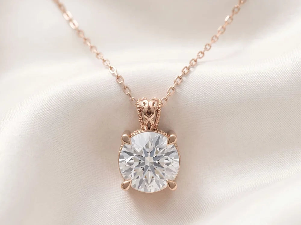 Rose gold solitaire pendant with a round diamond on ivory silk